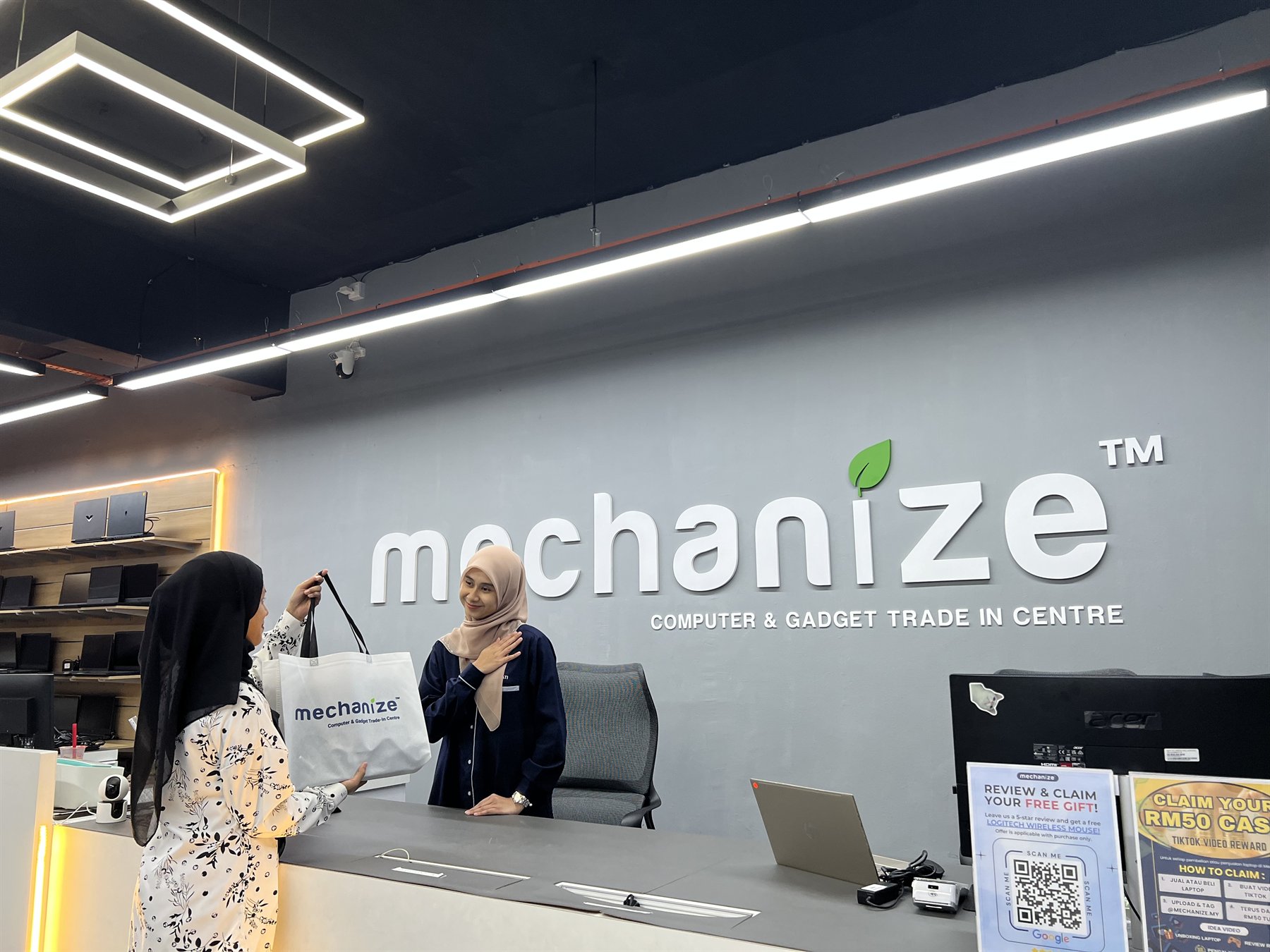 Mechanize team assisting a customer at the service counter